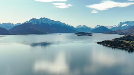 Dreamy aerial view from a mavic drone of the shoreline  of lake Wakatipu and its surrounding mountain ranges