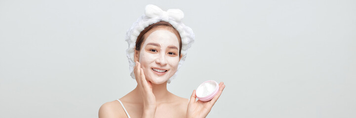 Beautiful woman with cosmetic mud facial procedure, spa health concept, banner