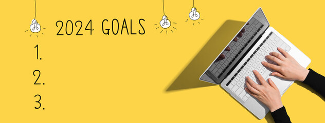 2024 goals with person using a laptop computer - obrazy, fototapety, plakaty