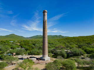 Fototapeta na wymiar Aerial drone view of the old “La Ramona” chimney in El Triunfo, Baja California Sur, Mexico