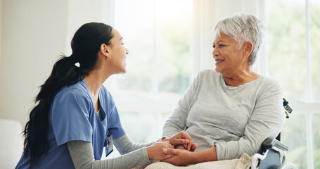 Happy woman, nurse and holding hands with senior in wheelchair, support or trust for healthcare advice at home. Medical doctor, caregiver or person with a disability smile for care or help at house