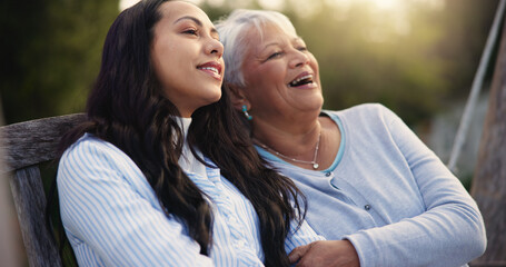 Happy, senior and mother with woman on bench, nature and bonding hug for laugh on retirement....