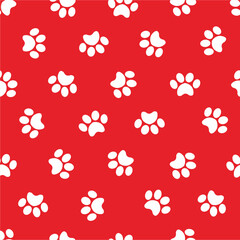 Dog foot prints background repeating design isolated on red background