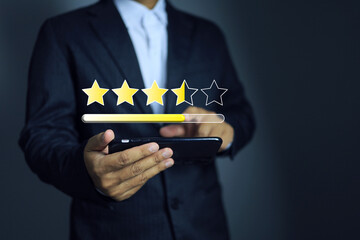Businessman rating on smartphone to give a feedback for products and service on customer...