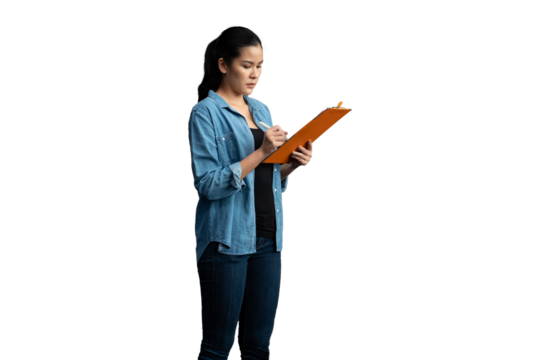 Portrait of female worker wearing safety uniform standing and working with clipboard on white background