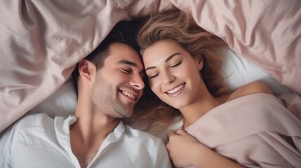 Top view of a very happy 1 young beautiful couple in bed - obrazy, fototapety, plakaty