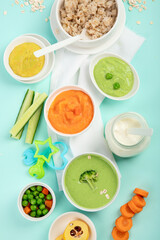 Bowls with different healthy baby food.