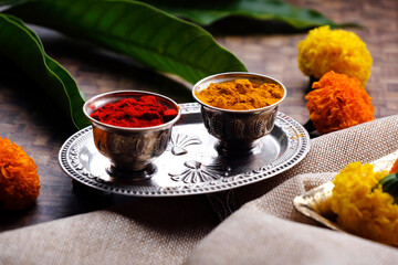 India's tradition Turmeric (Haldi) powder and kumkum powder in silver bowl for pooja.
