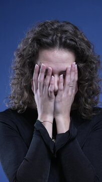 Frustrated woman covering face in shame feeling regret and despair in vertical video
