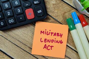 Concept of Military Lending Act write on sticky notes isolated on Wooden Table.