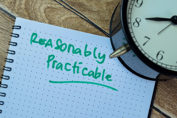 Concept of Reasonably Practible write on book isolated on Wooden Table.