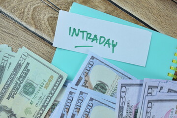 Concept of Intraday write on sticky notes with dollar isolated on Wooden Table.