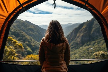 Woman looking out at nature from geo dome tents.