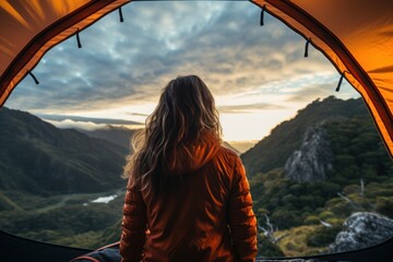 Woman looking out at nature from geo dome tents. - obrazy, fototapety, plakaty