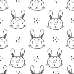 Seamless vector pattern in doodle style. Cute rabbit faces drawn by hand . Vector illustration