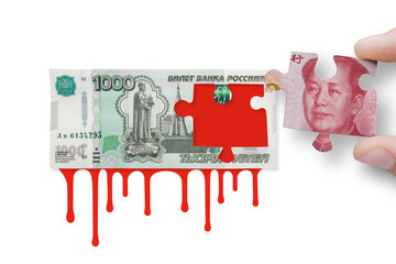 Russian rubles with blood and China yuan on a white background . Chinese yuan and Russian ruble banknotes. Russia and China collaboration