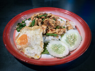 Stir-fried chicken curry paste with fried egg on rice