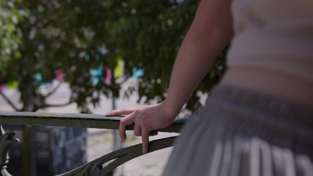 Woman in casual clothes and perfect body shape looking into Paris from balcony