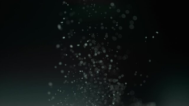 Small Air Bubbles Rising Up On A Clear Liquid In A Dark Environment