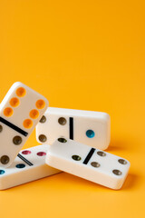 Domino tiles on yellow background studio shot