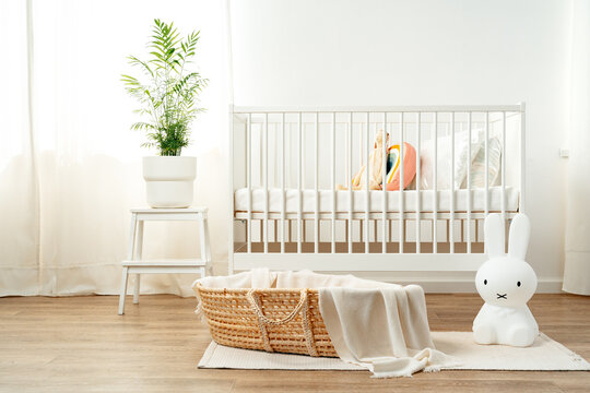 Interior of nursery room with baby crib and cradle