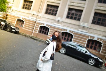 Young woman wearing sunglasses in city, colorful buildings and feel the warm. Exploring this bustling metropolis is a true adventure
