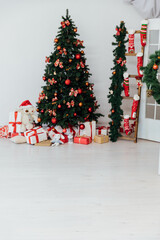 interior christmas. magic glowing tree, fireplace and gifts