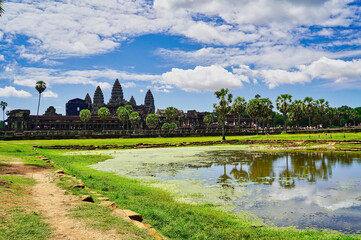 Angkor Wat Temple Complex reflected in the lake at mid day - UNESCO World Heritage 12th century...