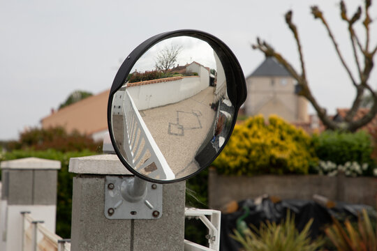 Traffic safety convex mirror near exit home portal on the street
