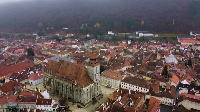 Drone circles around the Black Church in Council Square of Brasov during a cold winter day - Romania
