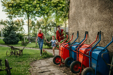 Obraz premium Loving family walking over the farm in the morning
