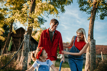 Shot of a man working his adorable wife and daughter on a farm