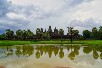 Fototapeta na wymiar Angkor Wat Temple Complex reflected in the lake at Sunrise - UNESCO World Heritage 12th century masterpiece of Khmer Architecture built by Suryavarman II at Siem Reap, Cambodia, Asia