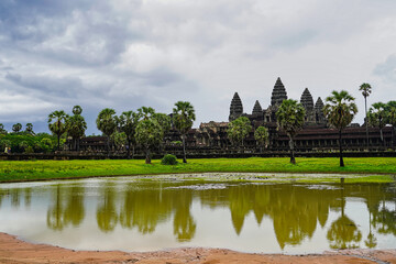 Angkor Wat Temple Complex reflected in the lake at Sunrise - UNESCO World Heritage 12th century masterpiece of Khmer Architecture built by Suryavarman II at Siem Reap, Cambodia, Asia