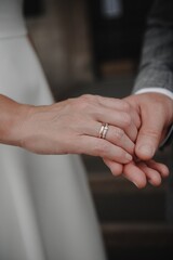 hands with an engagement and wedding ring close-up. Vertical image