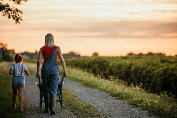 Rear view of a mother and daughter enjoying a countryside lifestyle.