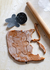 Making homemade Christmas gingerbread cookies. Dough for a gingerbread man on a light table. Shooting Flat lay
