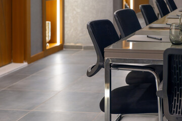 Close-up shot of the luxury meeting room chairs and tables with grey and black furnitures
