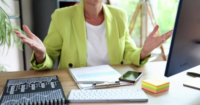 Unpleasantly surprised woman sitting with hands raised receiving bad unexpected news. Businesswoman outraged shocked business woman and reading business email and bankruptcy