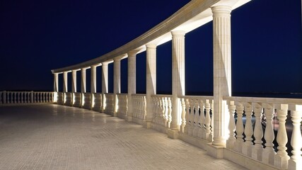 Antique landscape overlooking the balcony. The marble columns are illuminated at night.