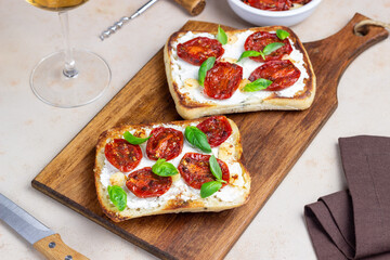 Ciabatta with sun-dried tomatoes, white cheese and basil. Italian food. Vegetarian food.