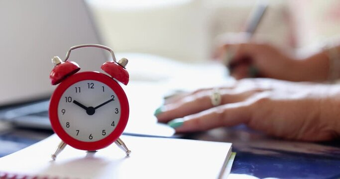 Business person worker writes notes and alarm clock. Working time concept Agenda time management and remote work and education