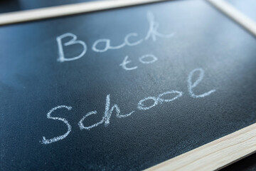 Fototapeta premium Text Back to school soon on blackboard