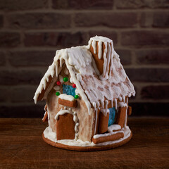 Christmas gingerbread house decorated with sugar icing and colorful candy