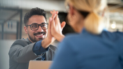 Business team people give high five in the office