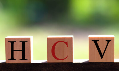 HCV made by wooden dice letters and color crossing for the related meanings of the concept.