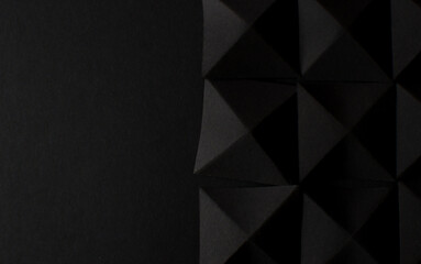Abstract black background with black geometric shapes, copy space