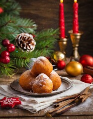 Obraz na płótnie Canvas Deep fried doughnut balls or Oliebollen at new years eve on table with powdered sugar.