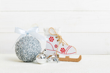 Christmas ball with skates on colored background. decoration bauble with ribbon bow with copy space