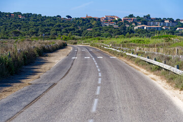 Scenic view at Giens Peninsula with diminishing perspective of rural road on a sunny late spring...
